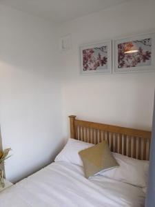 a bed with white sheets and a pillow on it at CityHost Apartments - Newcastle in Elswick