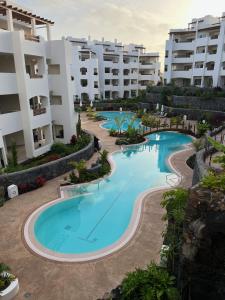 an overhead view of a swimming pool in a resort at Cozy apartment with pools in Palm Mar in Palm-Mar