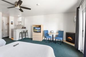 a bedroom with a bed and a table and a fireplace at Crown Motel in Kings Beach