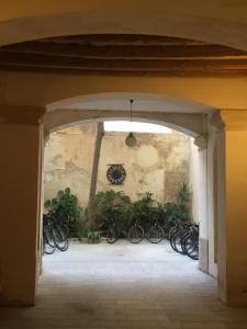an archway with bikes parked against a wall at Hotel Moderno in Trapani