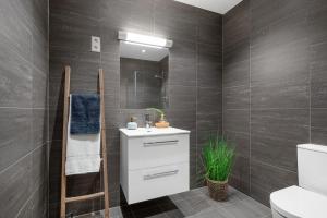 a bathroom with a white sink and a mirror at Apartment in Frogner Lillestrøm - Modern and Central in Lillestrøm