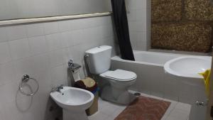 a bathroom with a toilet and a sink at Arcanjo Hostel 2 in Braga +50 photos
