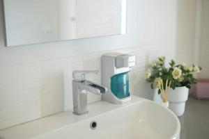 a bathroom sink with a faucet and a mirror at A due passi dal Duomo in Acireale