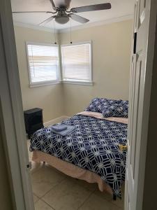 a bedroom with a bed and a ceiling fan at Sky Fresh Home Stay in Apple Valley