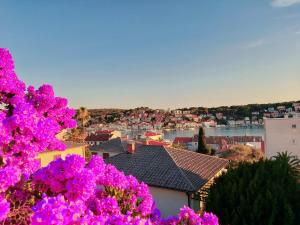 a view of a city with purple flowers at Apartment Sun view in Mali Lošinj