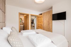 Łóżko lub łóżka w pokoju w obiekcie Granit Appartements