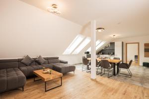 a living room with a couch and a table at Granit Appartements in Mauterndorf