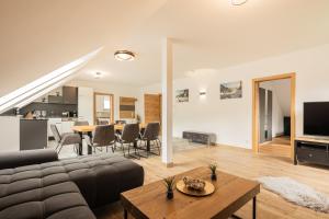 a living room with a couch and a table at Granit Appartements in Mauterndorf