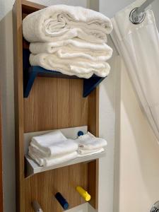 a towel rack with towels in a bathroom at Microtel Inn & Suites by Wyndham Stockbridge/Atlanta I-75 in Stockbridge