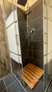 a shower with a wooden bench in a bathroom at Rome SuiteRelax in Rome