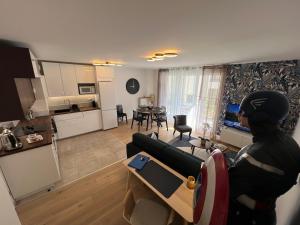 uma pessoa de pé em uma cozinha e uma sala de estar em Appartement 6 pers Val d'Europe - Disneyland Paris - Captain America em Chessy