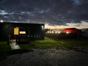 a train is parked next to a building at night at Pavillon Greve in Greve