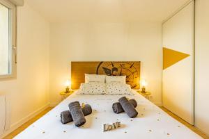 ein Schlafzimmer mit einem großen Bett mit zwei Kissen in der Unterkunft To Be Discovered L'escapade Cosy in Pradines