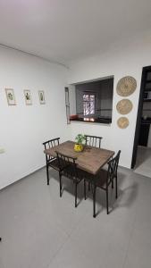 a dining room with a wooden table and chairs at Duplex Donovan in Resistencia