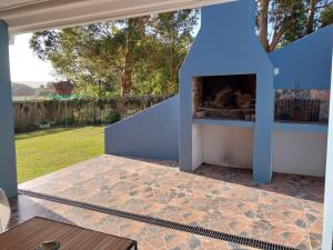 a fireplace in a yard with a patio at GUINEA FOWL in Plettenberg Bay