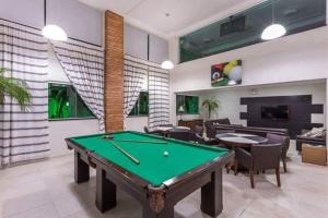 a living room with a pool table in it at Summer Beach Bombinhas SC in Bombinhas