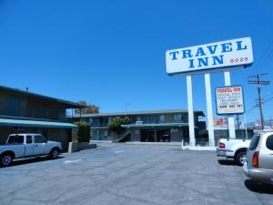 a sign for a travel inn in a parking lot at Travel Inn in North Hills