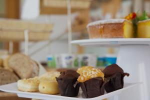 a plate with chocolate covered cookies and other pastries at Hotel Villa Clara in Nago-Torbole +53 photos