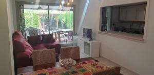 a living room with a red couch and a television at Precioso apartamento con dos terrazas privadas in Sant Jordi