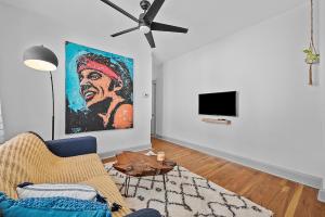 a living room with a couch and a painting on the wall at Center of Little Italy #1 in Cleveland