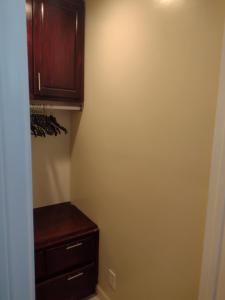 a closet with a wooden cabinet and a drawer at Sky Fresh Home Stay in Apple Valley