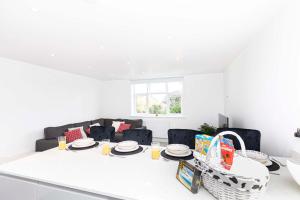 a white living room with a table and chairs at The White House - Lux Southbourne beach 3 bed stay in Southbourne