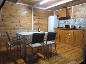 a kitchen with a table with chairs and a refrigerator at Domo Volcano Suite Experience in Arafo