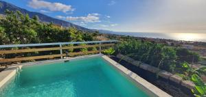 a swimming pool with a view of the ocean at Domo Volcano Suite Experience in Arafo
