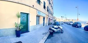 a scooter parked on the side of a street at La Casa di Pegli 21r in Genova