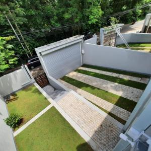 an aerial view of a backyard with a fence and grass at OESIS - Stylish Holiday Home in the heart of Galle in Galle