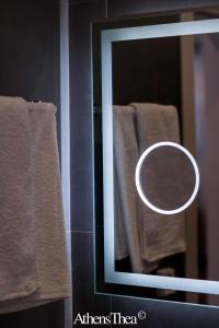 a mirror in a bathroom with towels on a rack at AthensThea Beta Luxury Penthouse Apt in Omonia in Athens
