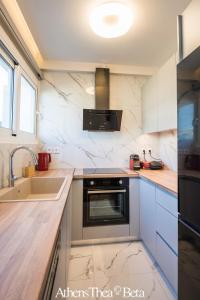 a kitchen with a sink and a stove at AthensThea Beta Luxury Penthouse Apt in Omonia in Athens