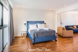 a bedroom with a blue bed and a couch at AthensThea Beta Luxury Penthouse Apt in Omonia in Athens