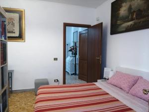 a bedroom with a bed with a striped blanket at In the Heart of Rome in Rome