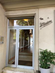 a glass door of a building with a sign on it at Loryhouse in Menton