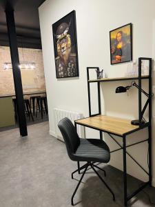 a room with a desk and a chair and a table at Loft atypique Dunkerque Centre in Dunkerque