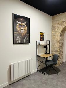 a room with a chair and a painting of a lion at Loft atypique Dunkerque Centre in Dunkerque