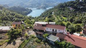 an aerial view of a village with a river and mountains at Casa da Laija - Gerês in Geres