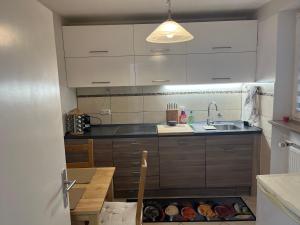 a kitchen with a sink and a table with food in a box at Bibis Ferienwohnung in Munich