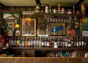 a bar filled with lots of bottles of alcohol at Jimmy OConnor's Windham Mtn Inn in Windham