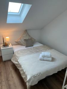 a bedroom with a bed with two towels on it at Ferienwohnung LiDu-JeNe in Eislingen +4 photos