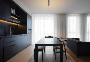 a kitchen and dining room with a table and chairs at Burbury Hotel in Canberra