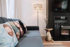 a living room with a couch with a fireplace at Bee Stays - Byron House in Manchester