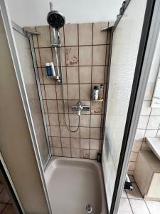 a shower in a bathroom with a tub at Praktisches Zimmer im Großen Haus mit garten in Düsseldorf