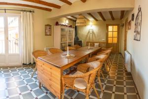 een eetkamer met een lange houten tafel en stoelen bij SidroAndCo Rural Home in Secastilla