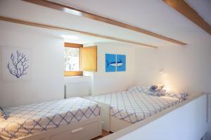 a bedroom with two beds and a window at casa con vista panoramica in Anacapri