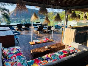 a room with chairs and tables and a large window at Pousada Rio144 in Rio de Janeiro