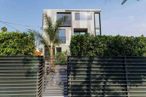 a building with a fence in front of it at Stunning Hollywood Townhouse with Sunny views in Los Angeles