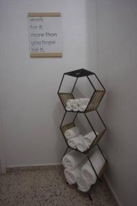 a towel rack with folded towels in a room at Cozy apartment in the heart of the city in Ponce