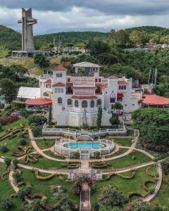 an aerial view of a large white building with a fountain at Cozy apartment in the heart of the city in Ponce